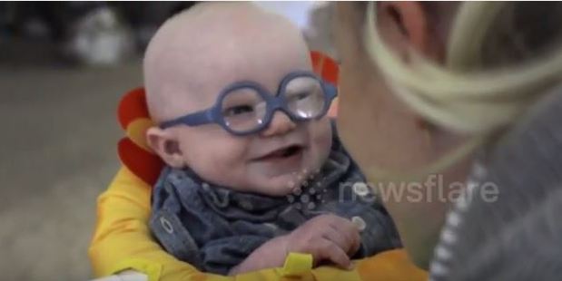 Baby Leopold's reaction is a huge smile for his mum, while others in the room can be heard gasping in delight. Photo / YouTube, Newsflare