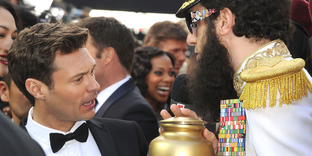 Sacha Baron Cohen threw ashes on Ryan Seacrest at the Oscars in 2012. Photo / Getty Images