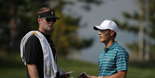 Danny Lee and caddie Kurt Kowaluk at The Presidents Cup last year. Photo / Getty Images