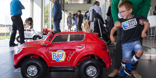 Benjiro Fenwick checks out his new 'GoBabyGo' car at BMW. Photo / Greg Bowker