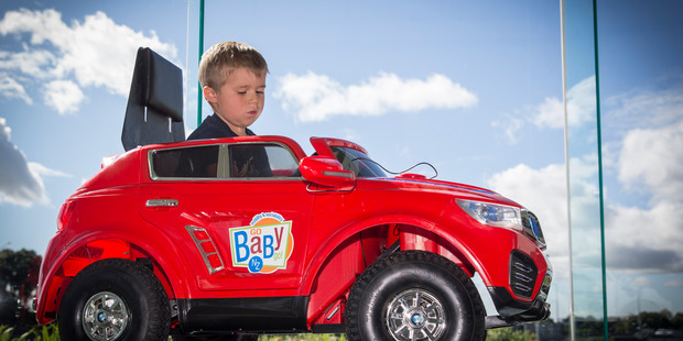 Ethan King, 4, who has Muscular Dystrophy test drives his new 'Go Baby Go' car. Photo / Greg Bowker