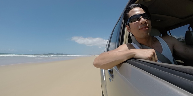 The writer drives down Teewah Beach, Sunshine Coast. Photo / Andrew Louis