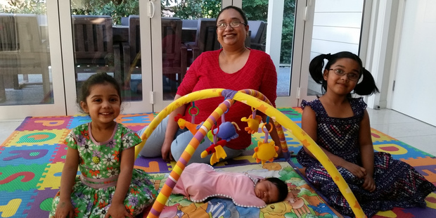 Newborn Tessa Menezes with mother Natasha and sisters Caitlin, 2, and Olivia, 6, has had to wait. Photo / Supplied