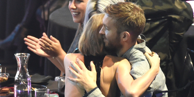 Taylor Swift hugs Calvin Harris after she was announced as the winner of the female artist of the year award during the iHeartRadio Music Awards. Photo / AP