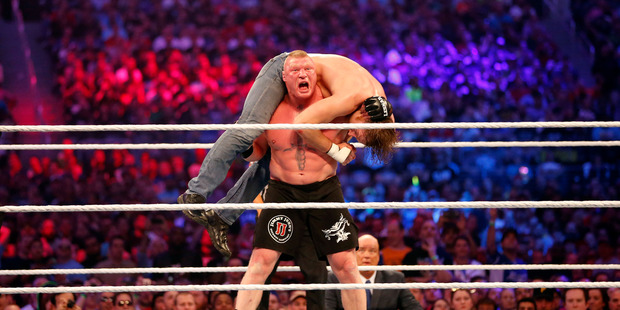 Brock Lesnar, in black shorts, wrestles Dean Ambrose during WrestleMania 32 at AT&T Stadium in Arlington, Texas, Sunday, April 3, 2016. (Jae S. Lee/The Dallas Morning News via AP)