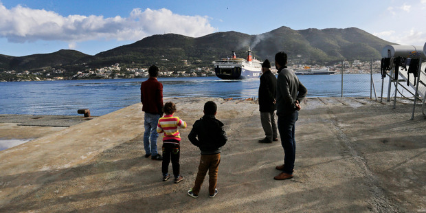 Refugees at the port of the eastern Greek island of Samos, where tourist bookings are in decline. Photo / AP