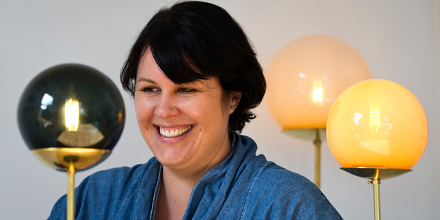 Designer Rebecca Dowie of Douglas and Bec with her favourite design piece, the Line Lamp. Photo / Jason Oxenham