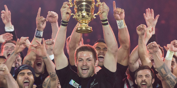 Richie McCaw holds aloft the Webb Ellis Trophy after winning the Rugby World Cup Final. Photo / Brett Phibbs