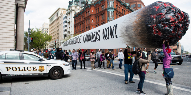 Secret Service block pro-marijuana protesters from carrying their 51-foot inflated marijuana joint down Pennsylvania Avenue in front of the White House. Photo / Getty Images