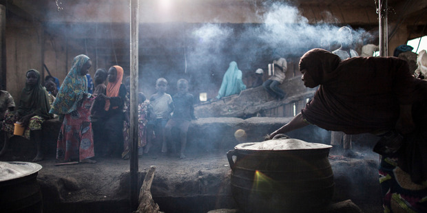 A woman prepares food at the children's kitchen at the Dalori Internally Displaced Persons Camp. Photo / Jane Hahn, Washington Post