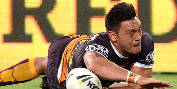 Alex Glenn of the Broncos scores a try against the Dragons. Photo / Getty