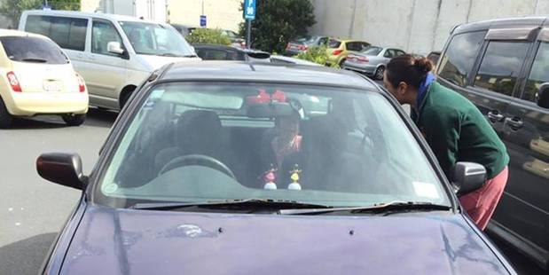 A bystander tries to help the baby calm down while others search for the mother. Photo / Facebook