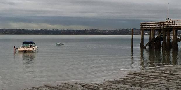 The car is partially submerged as the tide comes in. Photo / Anna Pilkington