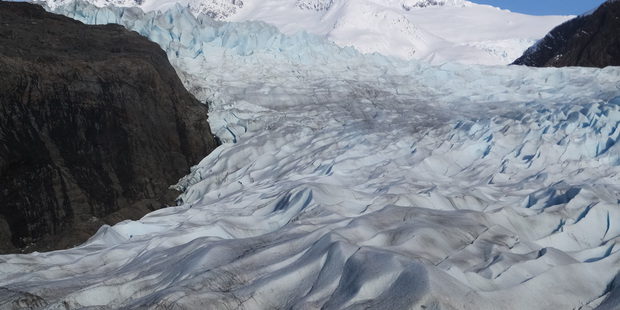 Snow-covered mountains are seen behind the Mendenhall Glacier in Juneau, Alaska. Photo / AP