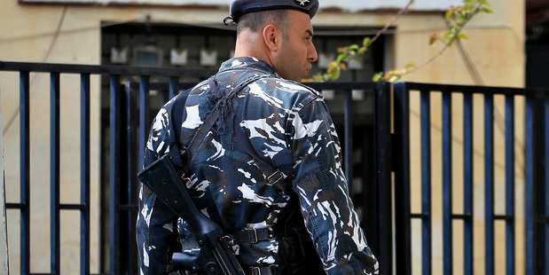 A Lebanese policeman stand guards at the entrance of the courthouse compound holding the nine suspects of kidnapping two Lebanese-Australian children in Beirut. Photo / AP