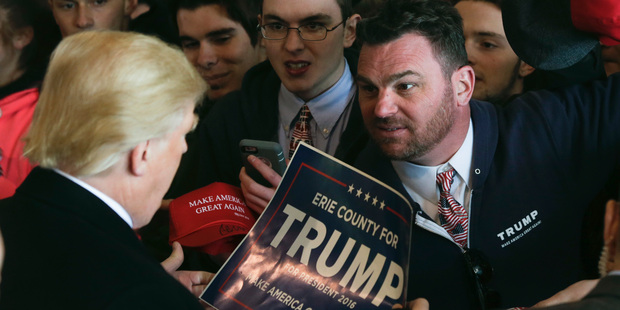 Supporters of Republican presidential candidate Donald Trump get autographs after a rally in Rochester, New York. Photo / AP