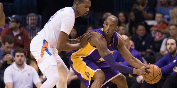 Kobe Bryant tries to drive around Kevin Durant during the first quarter of a NBA game. Photo / Getty Images