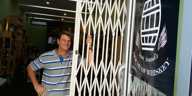 Sam Snead, owner of House of Whiskey, in Chancery Square central Auckland, has installed a folding security gate and curtains, after $10,000 worth of liquor was stolen from his store.