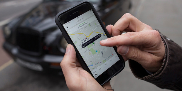 A customer uses the Uber mobile phone app. Photo / Getty Images
