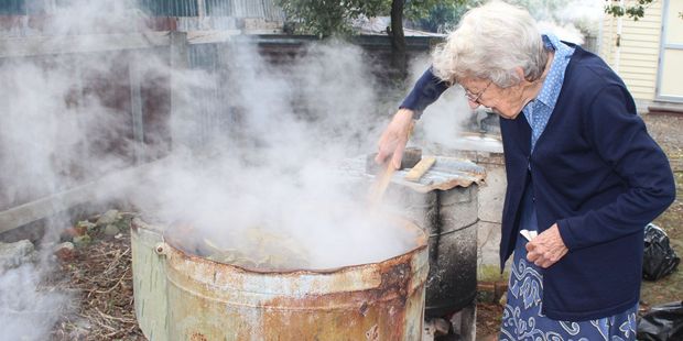 Pat Hewitt stirs the copper containing silver dollar leaves at the Dannevirke Spinners and Weavers dye day on Saturday.