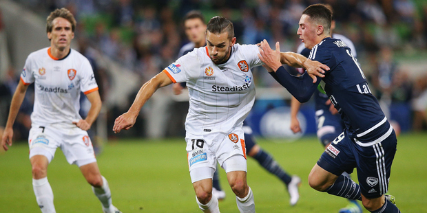 Jack Hingert of Brisbane Roar (C) competes for the ball against George Howard of the Victory. Photo / AP.