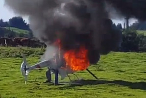 The helicopter on fire at Tikitere. Photo/Rob Tane