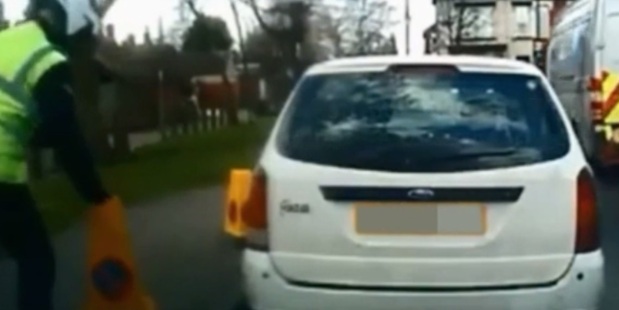 Footage clearly shows the warden move the cone before issuing a ticket. Still / MailOnline