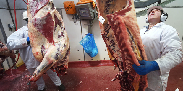 A factory worker moves cattle carcasses from the chill room to the boning room at a Bindaree Beef facility in Inverell, Australia. Photo / Bloomberg