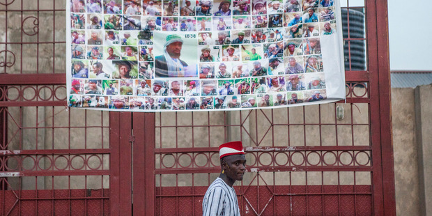 A Boko Haram's 'Most Wanted' poster hangs on a gate in Maiduguri, Nigeria. Photo/ The Washington Post by Jane Hahn.