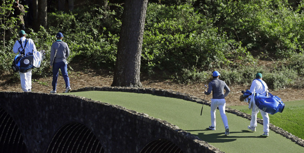 Jordan Spieth, left, crosses over the Hogan Bridge with Rory McIlroy during the Masters. Photo / AP