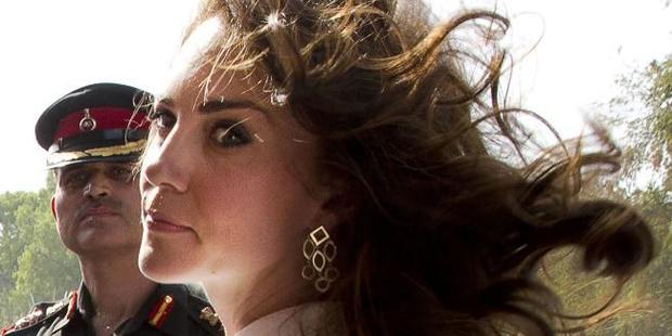 The Duchess of Cambridge battles the wind in a sombre moment in India. Picture: AFP/Manish Swarup / Getty Images