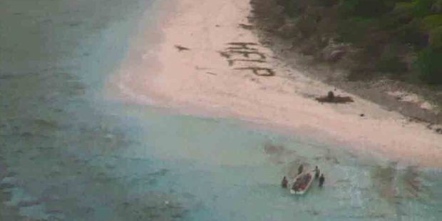 A small boat from Pulap recovers three men from the uninhabited island of Fanadik after they were discovered by a U.S. Navy plane. Photo / U.S. Navy