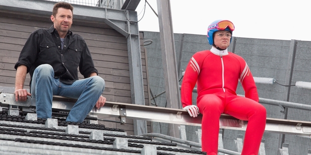 Hugh Jackman and Taron Egerton get into role as coach and ski-jumper.