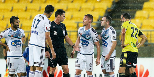 Andrew Durante of the Phoenix looks on as Besart Berisha of the Victory lies on the ground. Photo / Getty Images.
