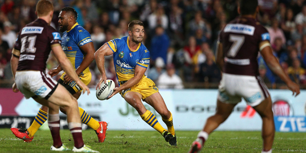 Kieran Foran (centre) of the Eels takes on former team, the Manly Sea Eagles at Brookvale Oval. Photo / Getty