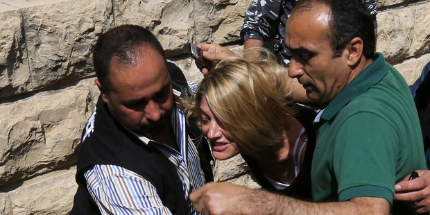 Lebanese policemen surround Australian TV presenter Tara Brown while escorting her from a Lebanese courthouse to Baabda Prison for women, in Baabda east of Beirut. Photo / Getty Images