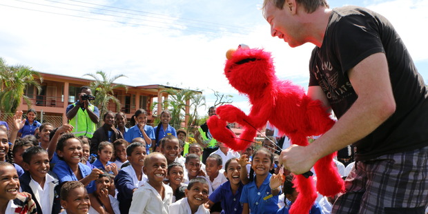 Chris Lynch with Elmo and his fans. Photo / Corinne Ambler/IFRC