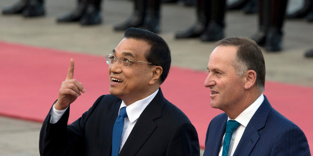 Prime Minister John Key, right, and Chinese Premier Li Keqiang, left, chat during a welcome ceremony outside the Great Hall of the People in Beijing, China. Photo / AP