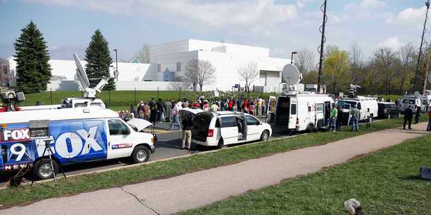 Media satellite trucks and fans line the street outside Paisley Park. Photo / AP