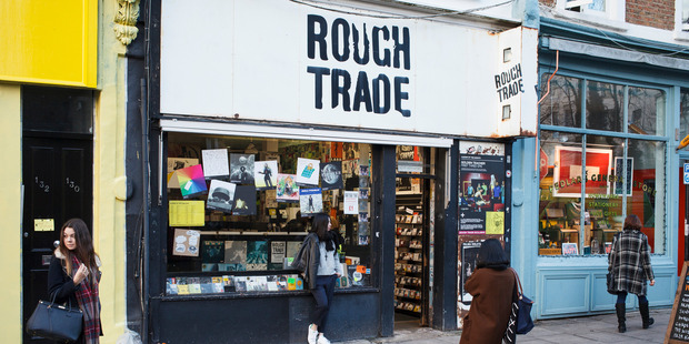 Tourists take photos outside the Rough Trade record shop in London. Photo / AP