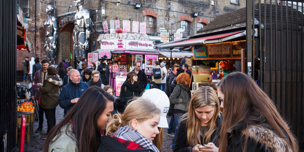 Tourists and locals mingle in Camden Market in London. Photo / AP