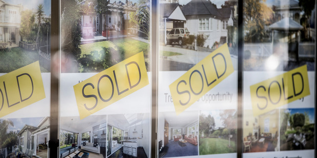 Real estate agent windows showing houses for sale. Photo / Michael Craig