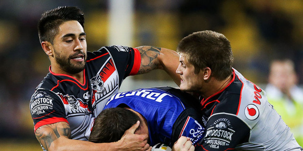 Josh Morris of the Bulldogs is tackled by Shaun Johnson and Blake Ayshford of the Warriors. Photo / Getty Images.