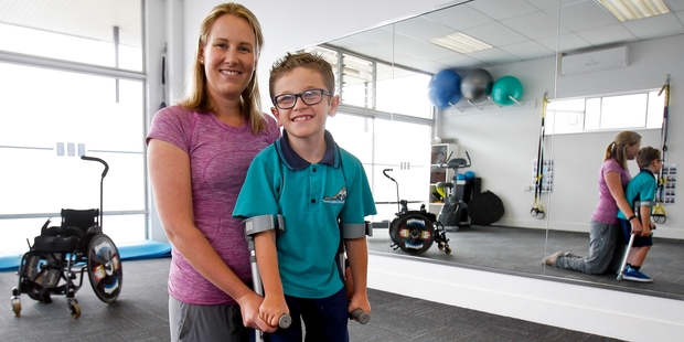 DETERMINED: Austin Manning, with his physiotherapist Amanda Meys, at Avenues Physio-Fitness where he has been strengthening his limbs for his operation. PHOTO/RUTH KEBER