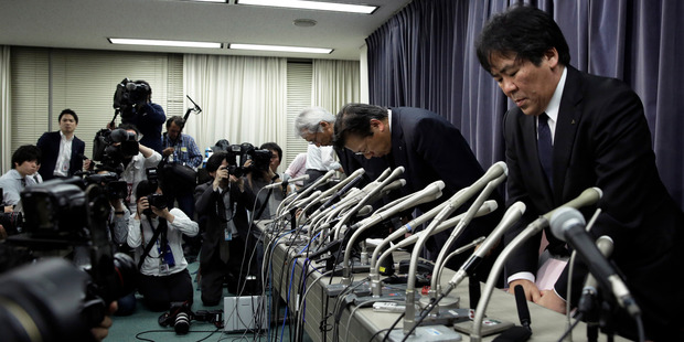 Top officials of Mitsubishi Motors bow at the end at the end of a news conference in Tokyo after admitting to manipulating fuel economy test data. Photo / Bloomberg