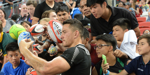 Sonny Bill Williams takes a selfie with fans during the Singapore Sevens rugby tournament. Photo / AFP