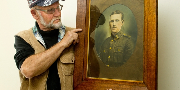 UNCOVERED: Jacob Boulain holds a framed photograph of Sergeant Sullivan and is keen to give it back to his family if he can find them. PHOTO/WARREN BUCKLAND