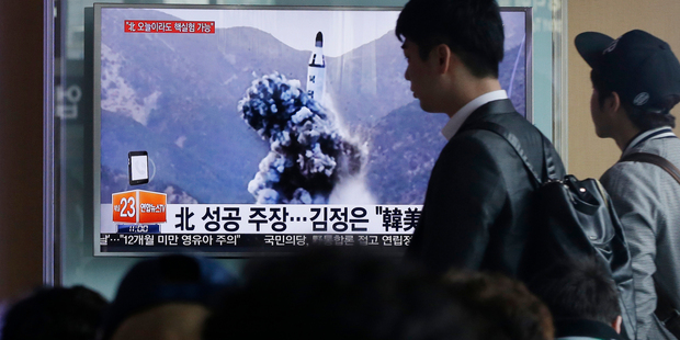 A TV news programme shows an image published in North Korea's Rodong Sinmun newspaper of a ballistic missile that the North claimed to have launched from a submarine. Photo / AP