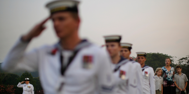 Australian Navy personnel from the HMAS Albany and HMAS Melville together with members of the public at a dawn Anzac service. Photo / AP