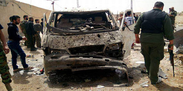 The scene after a suicide bomber detonated his explosives-packed vehicle at a military checkpoint in Damascus. Photo / AP
